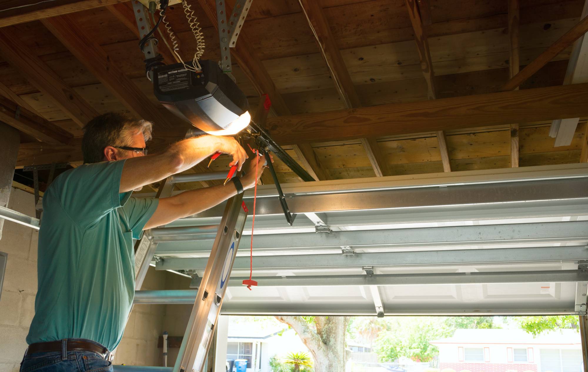 Technician working on overhead garage door hardware