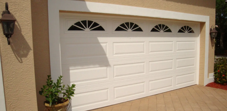 White residential garage door with arched windows